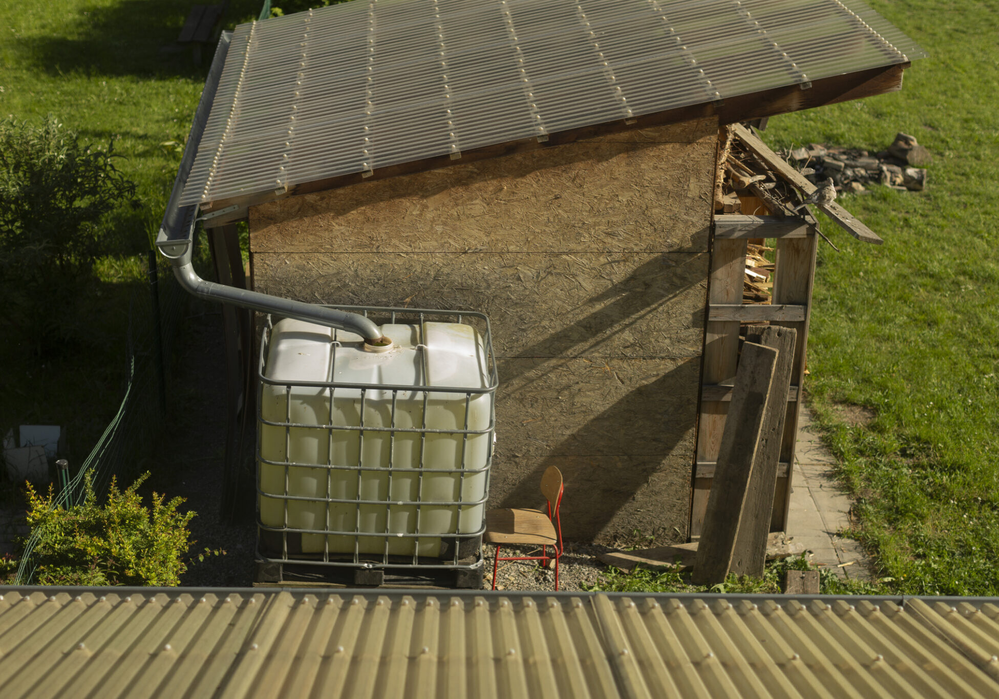 Outdoor water storage beside garden shed